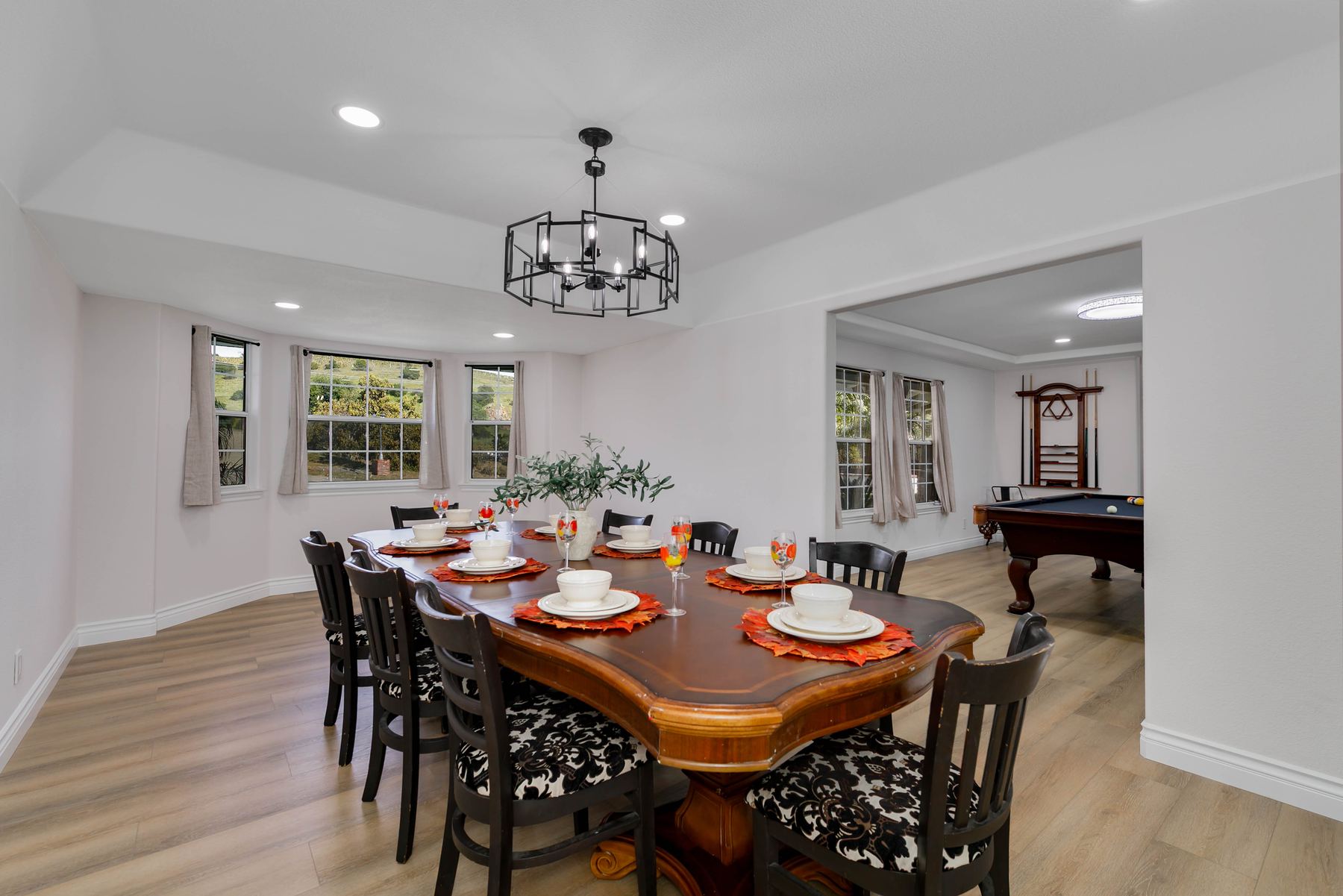 Dining table set for ten with a pool table in the great room